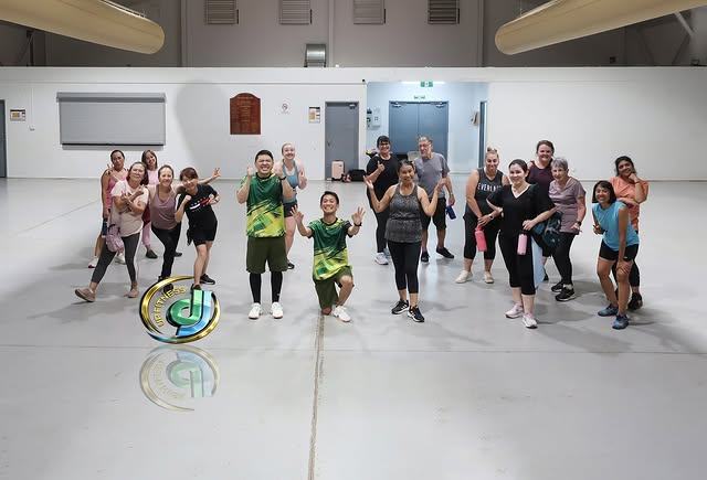 A class lined up for a photo across the width of the sports hall.