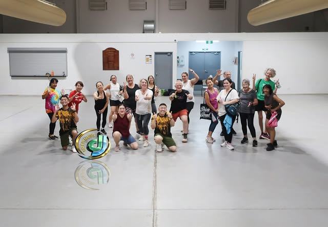 Class members with arms around each other for a group photo after class.