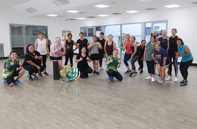 Participants posing together in the studio room after a morning class.