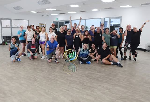 A post-class group photo in the studio with the class gathered close.